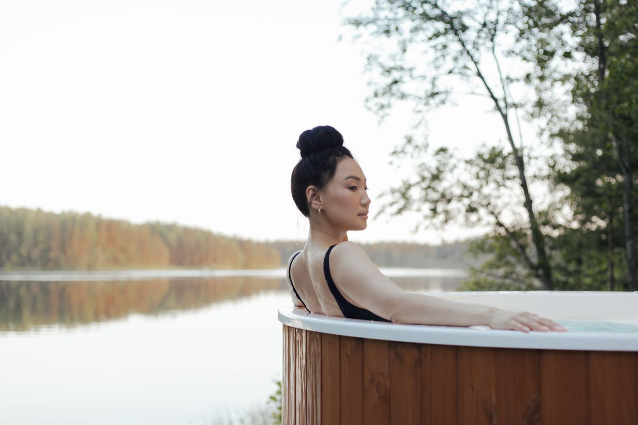 Žena relaxující ve venkovní vířivce s aromaterapií